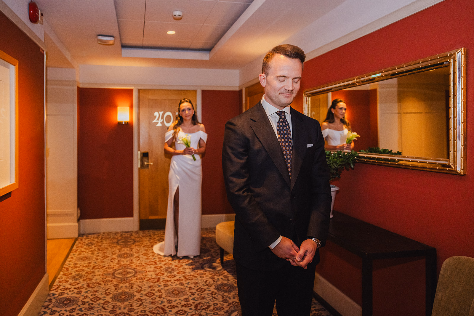 Gintare and Mikael seeing one another in the red corridor at Hotel Diplomat before their City Hall wedding.