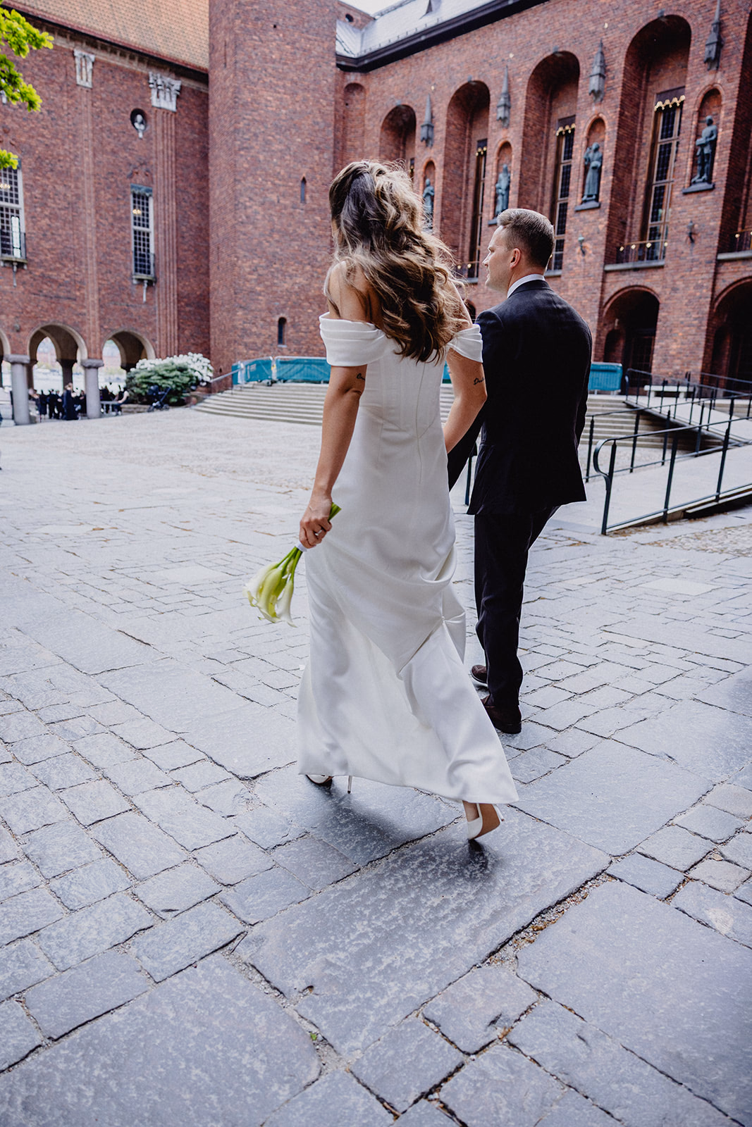 Gintare and Mikael walking across the courtyard on arrival at Stockholm City Hall.