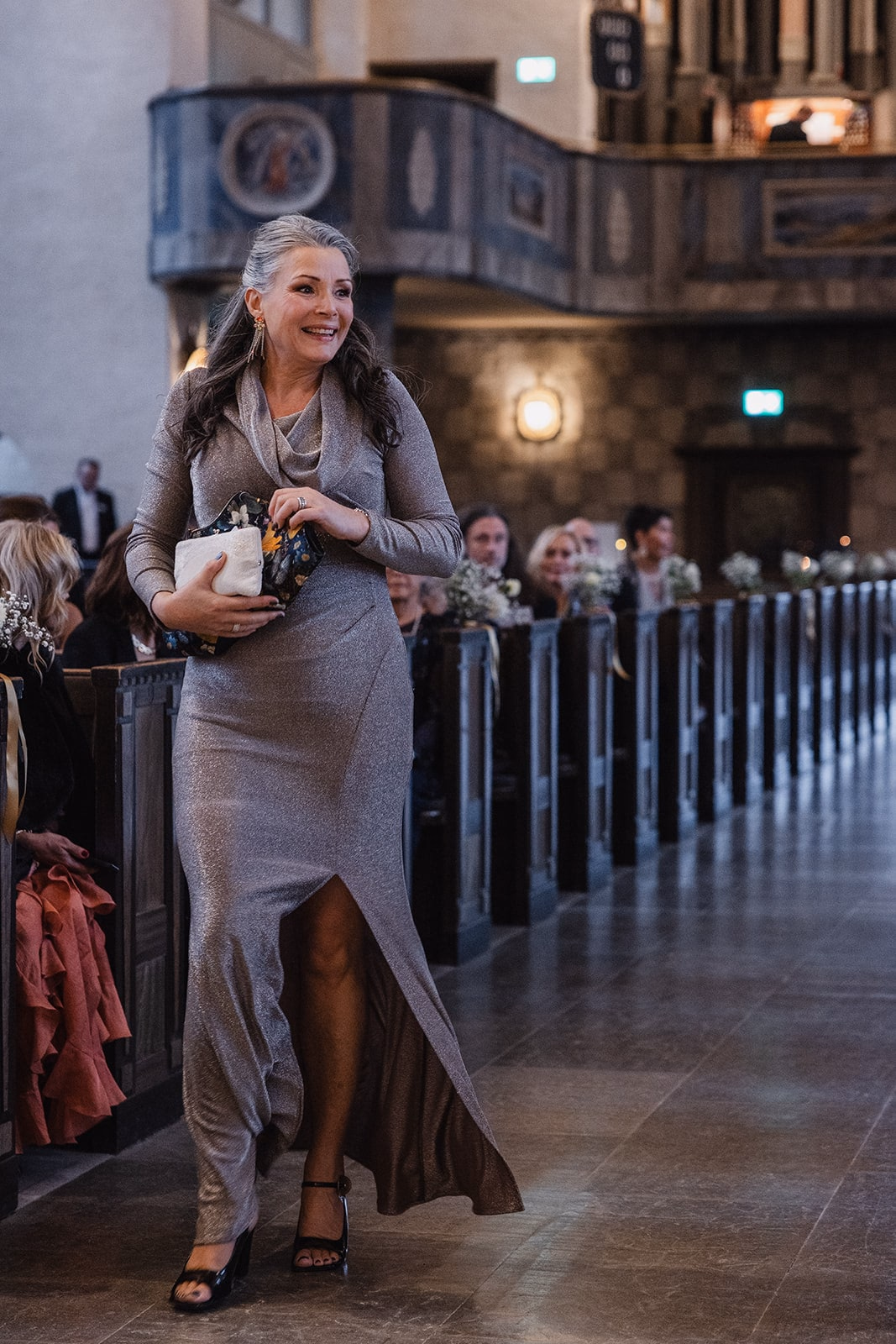 A member of the wedding party walking down the aisle at Högalidskyrkan.