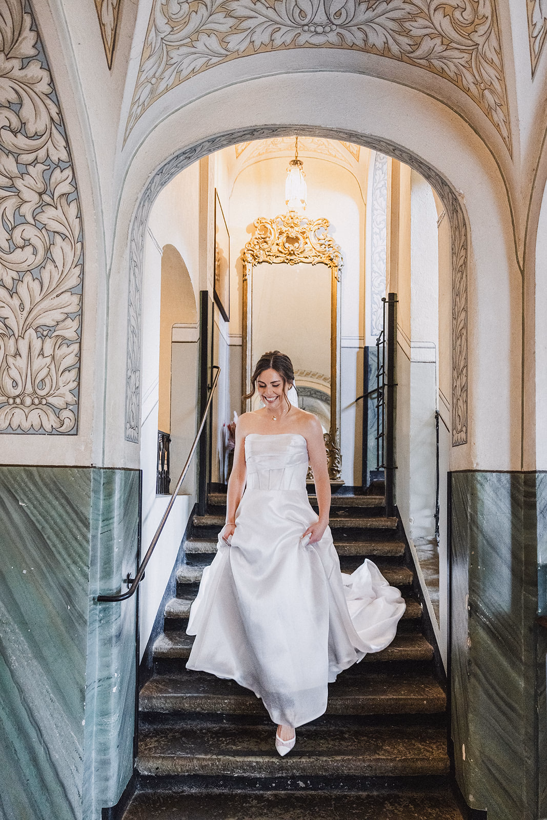 The bride approaching the first look through the manor hallway.