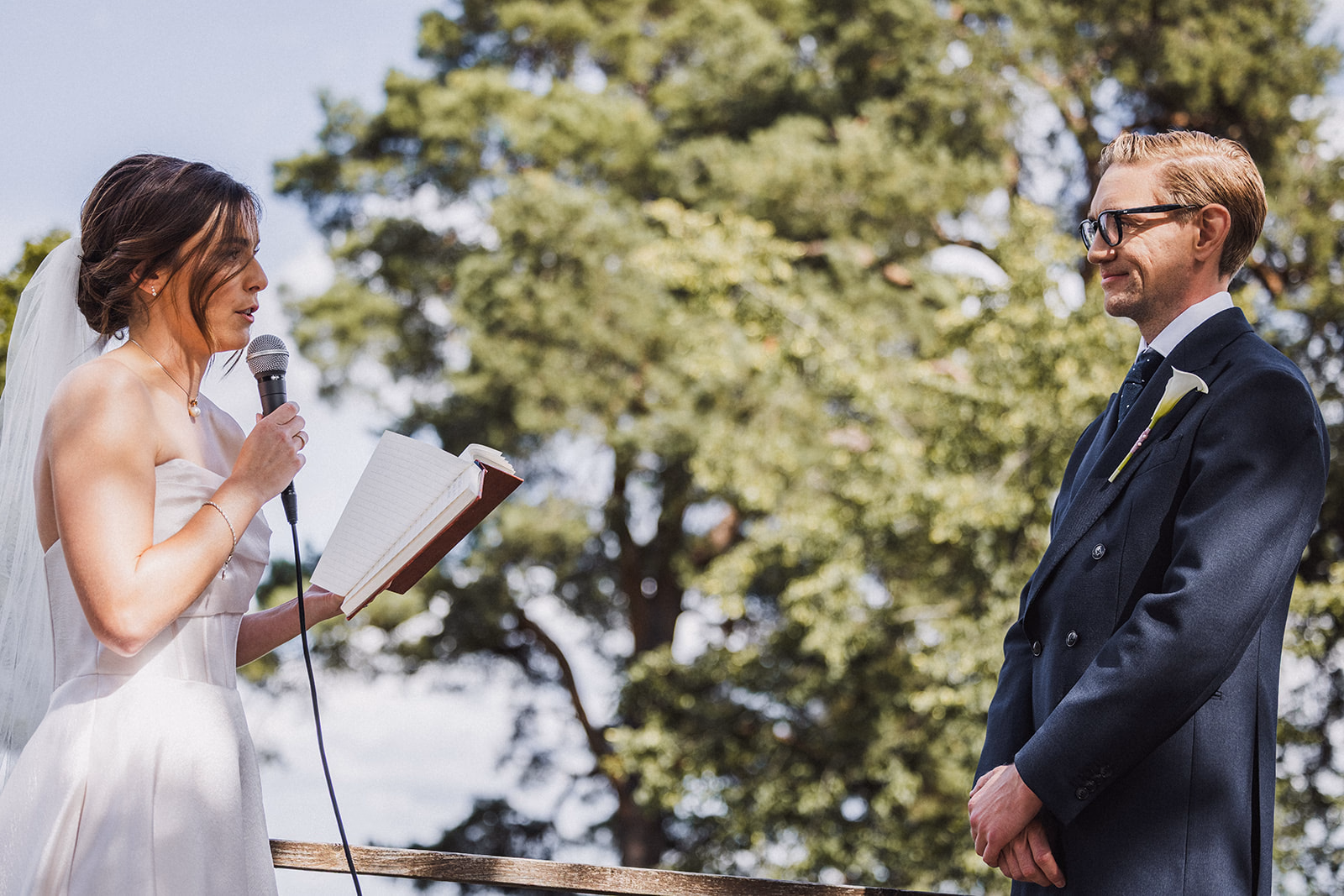 The bride reading her vows during the outdoor ceremony.