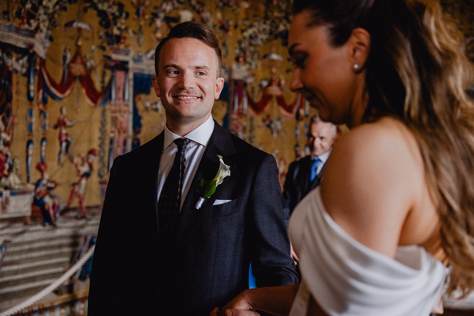The groom smiling at the bride during their Stockholm City Hall ceremony.