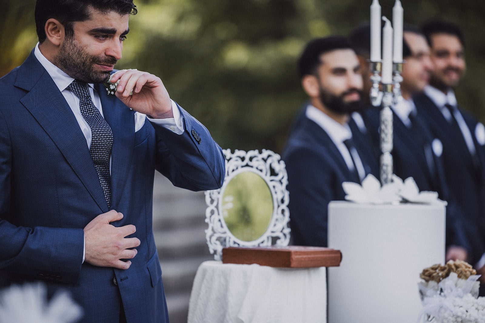 Kamran wiping away tears during the ceremony.