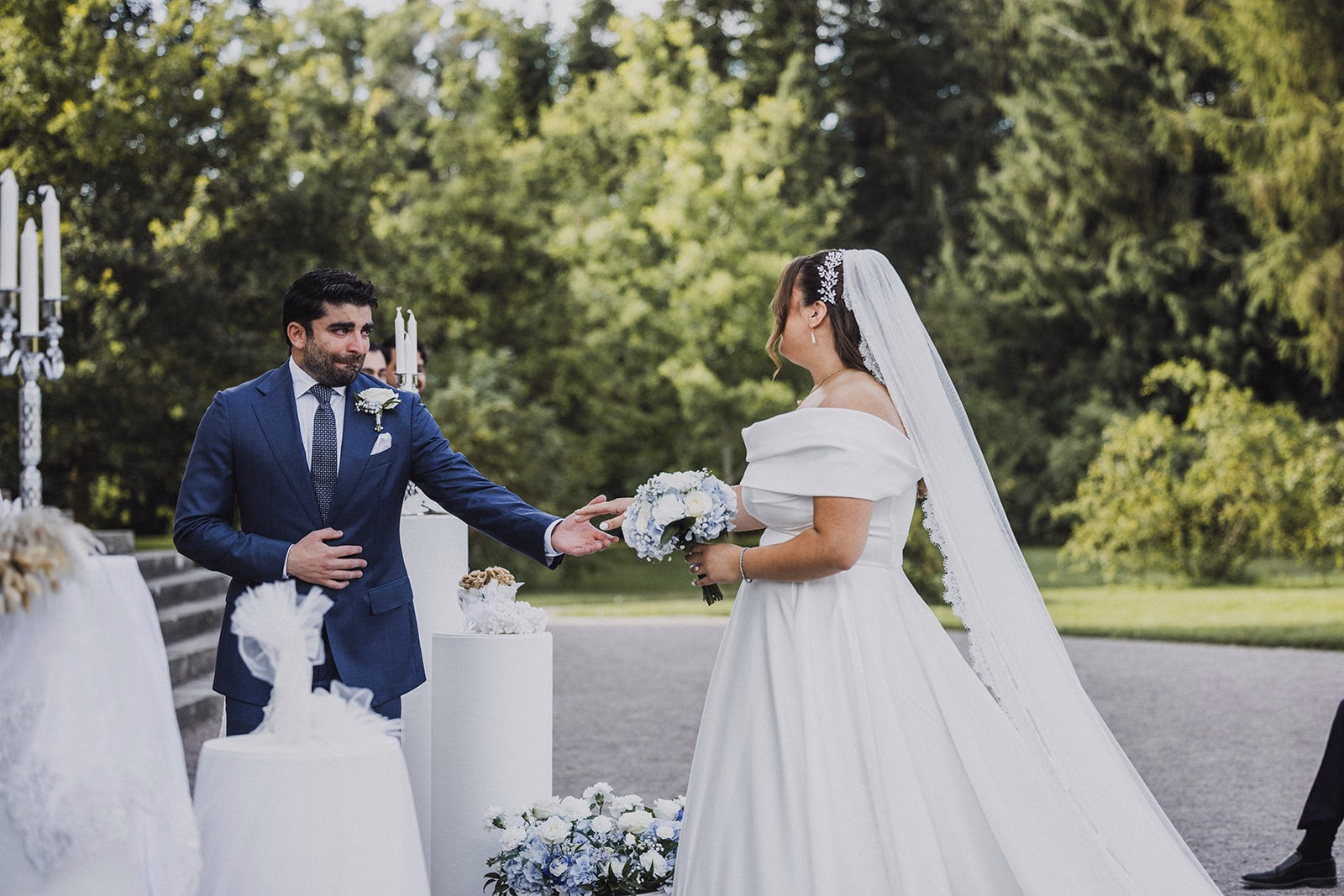 Sara and Kamran reaching for one another at the ceremony.