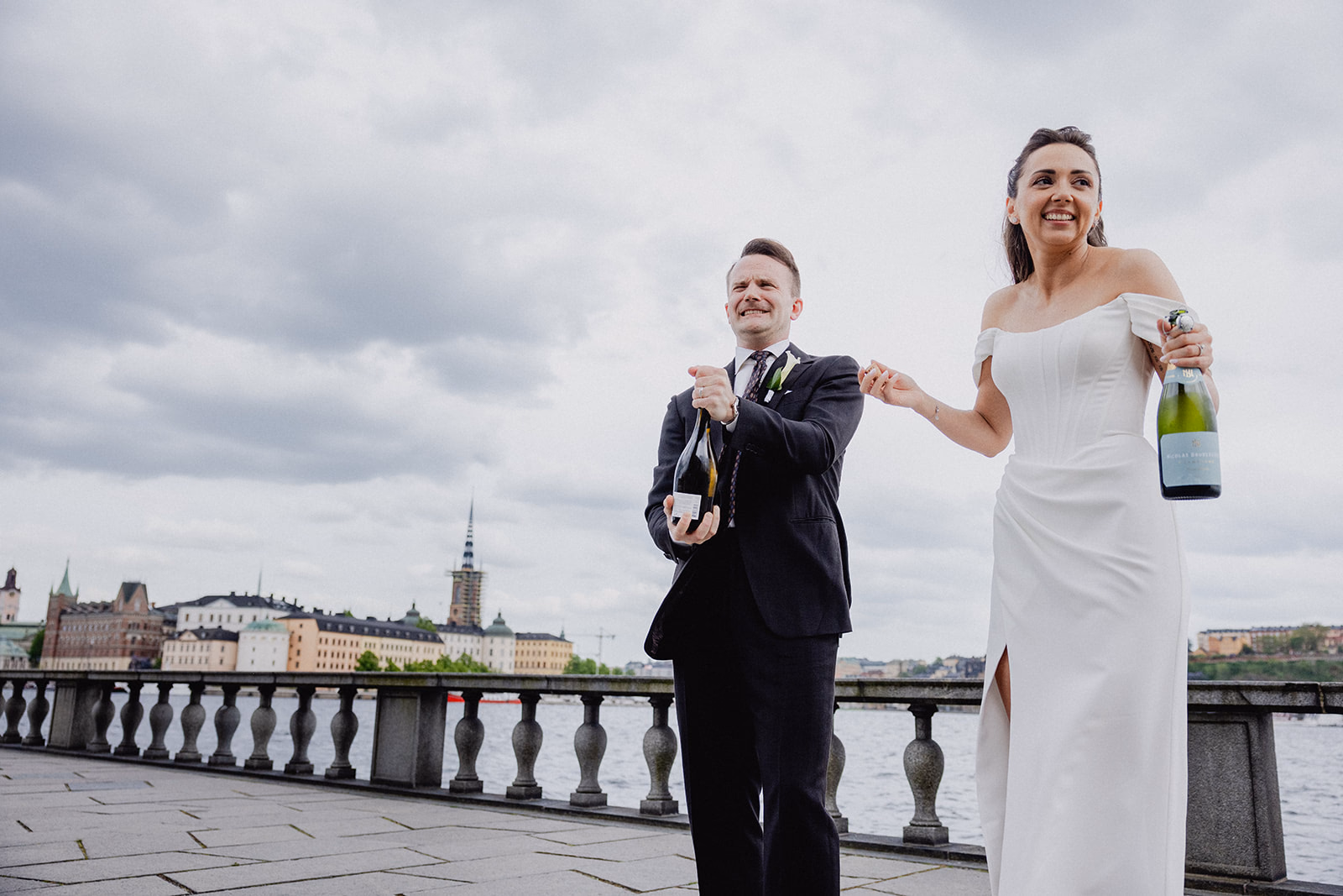 Gintare and Mikael opening champagne on the Stockholm City Hall terrace after their ceremony.