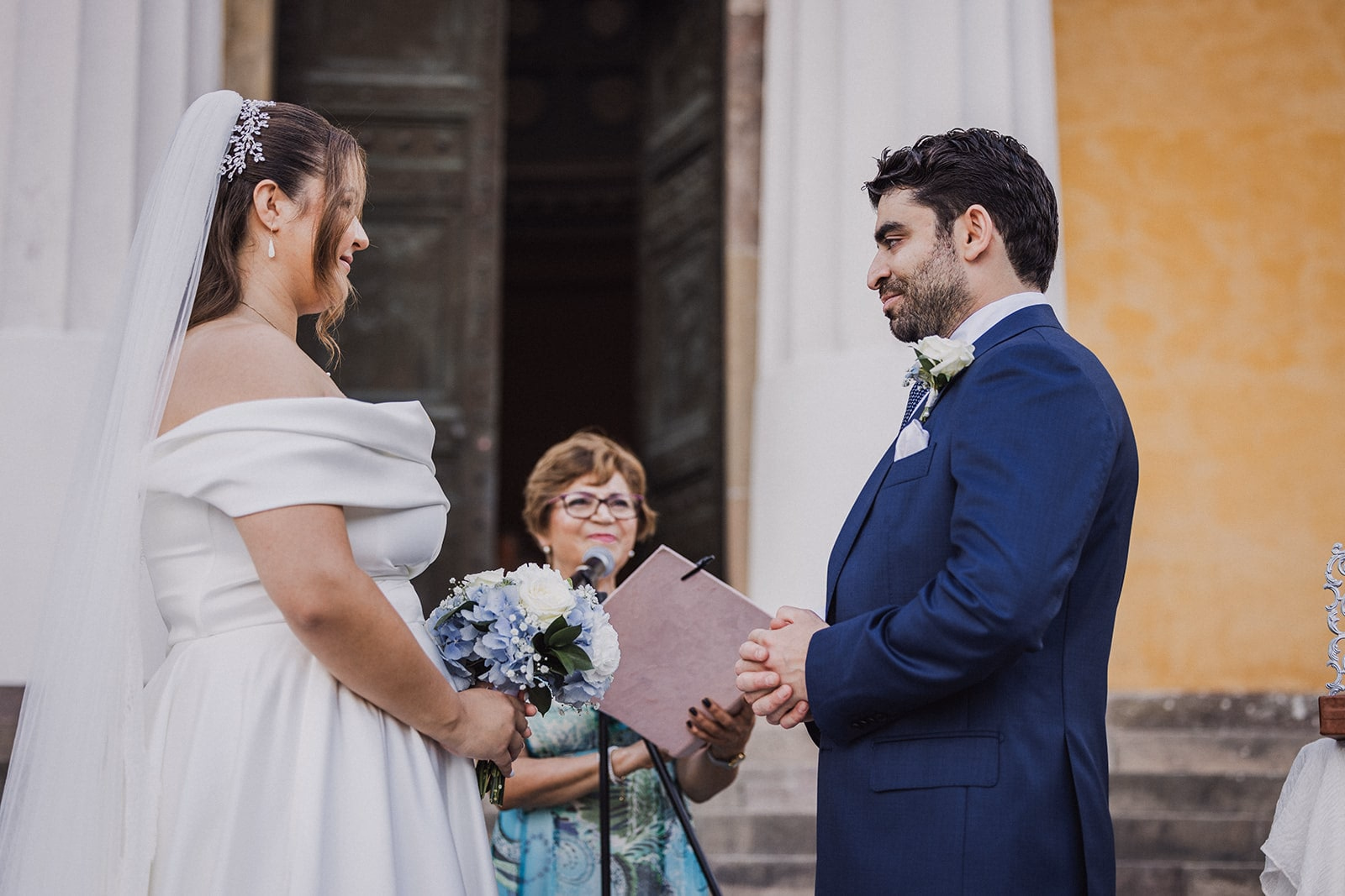 Sara and Kamran exchanging vows during the garden ceremony.