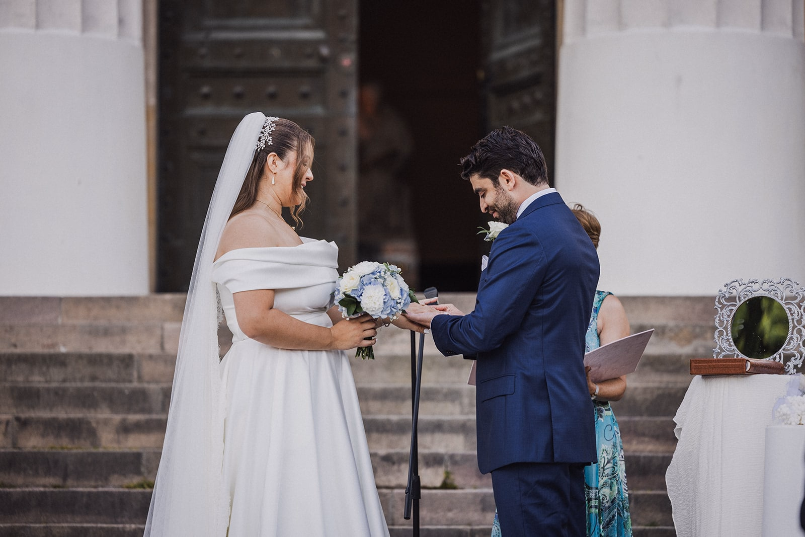 The couple exchanging rings during the outdoor ceremony.
