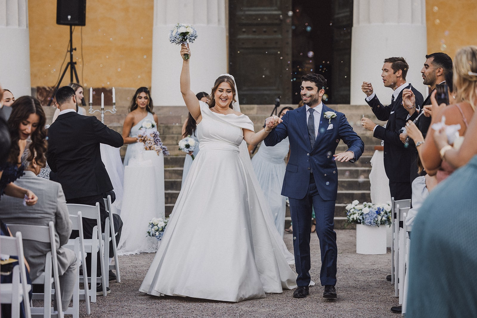 The newlyweds celebrating between guests and bubbles after the ceremony.