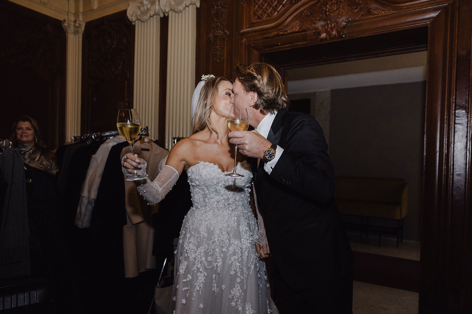 The newlyweds embracing as they arrive at their reception.