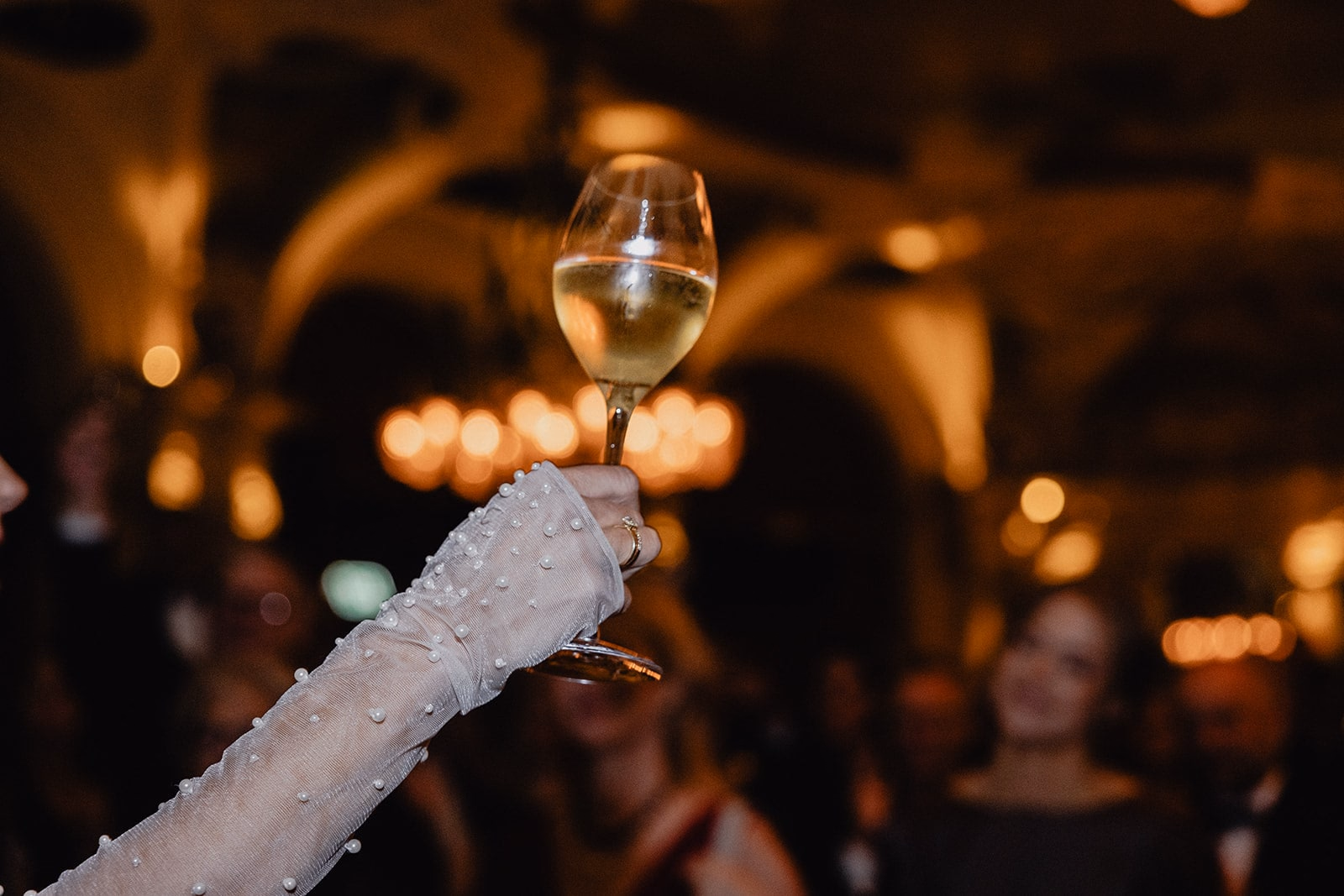The bride raising a glass during the reception at Café Opera.