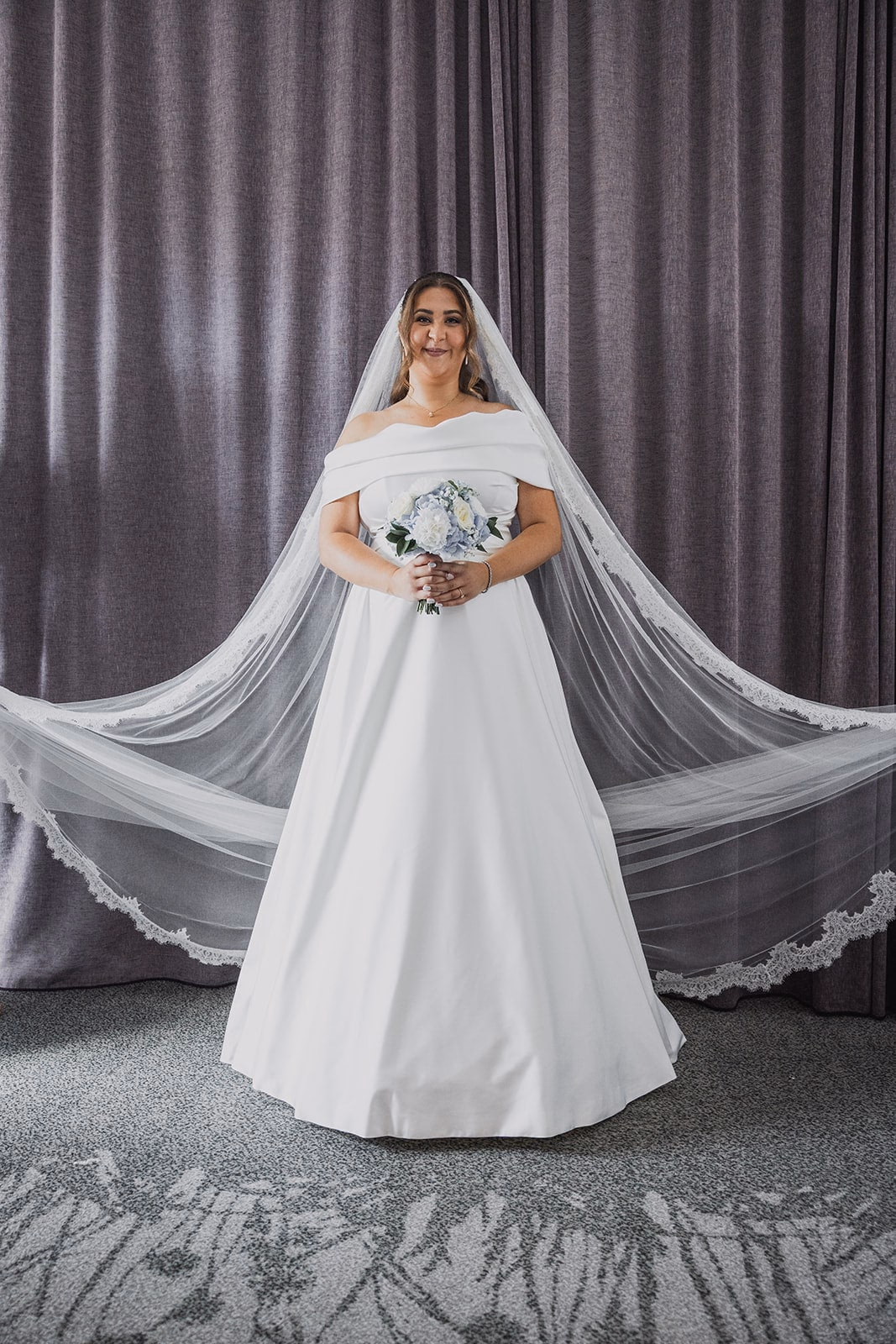 Sara standing for a full-length portrait before the ceremony.