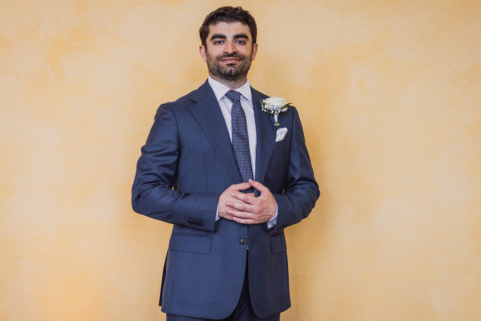 Kamran standing for a portrait beside the Linneanum.