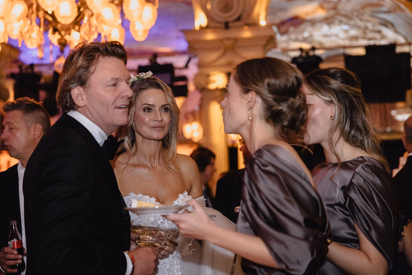 The newlyweds talking with wedding guests during the reception.