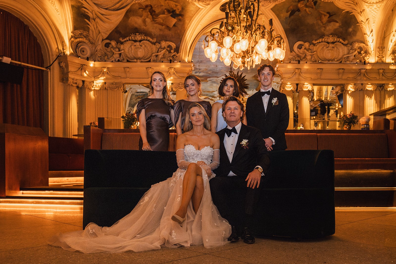The newlyweds posing with family members inside Café Opera.