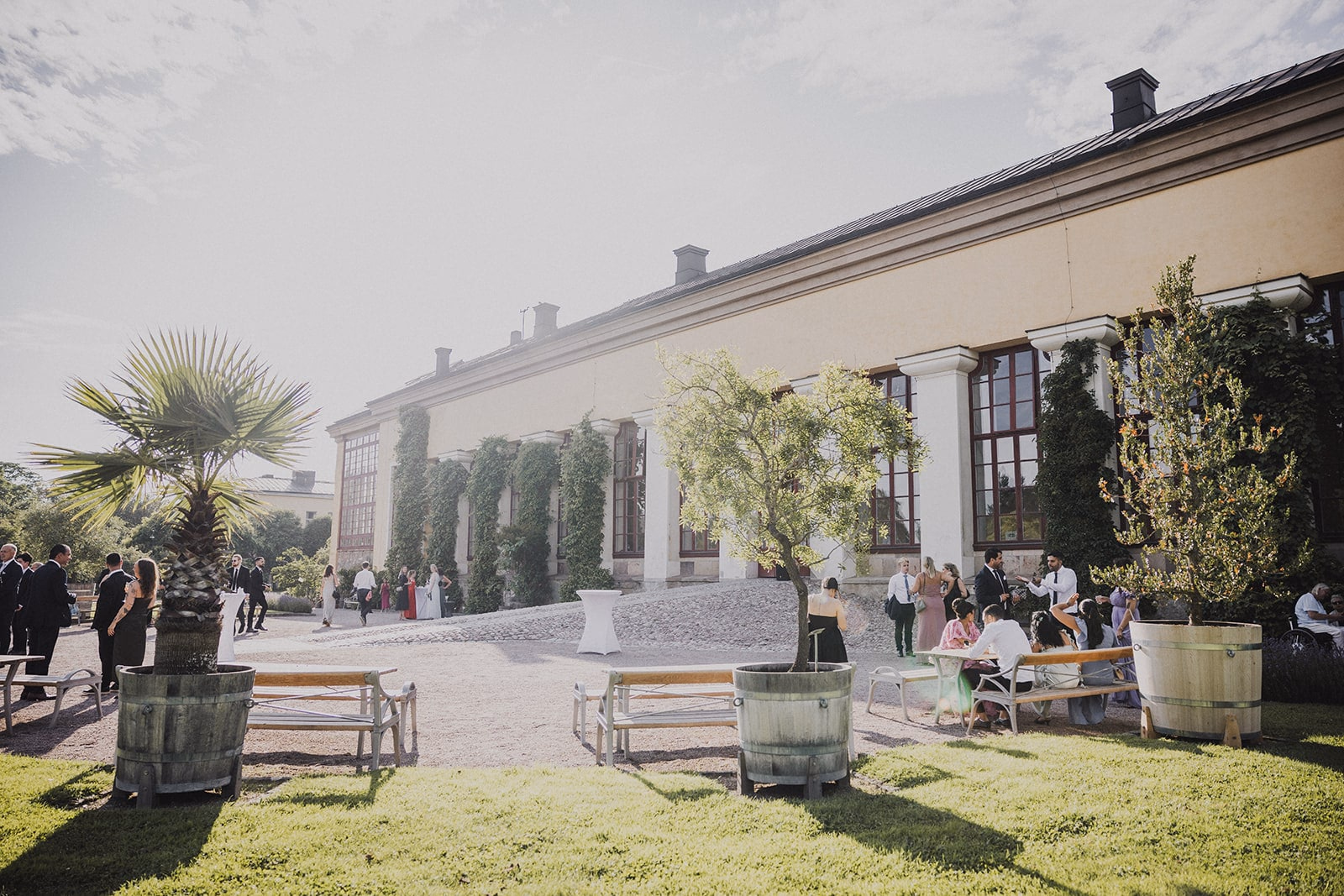 Guests gathering outside for the summer wedding reception.