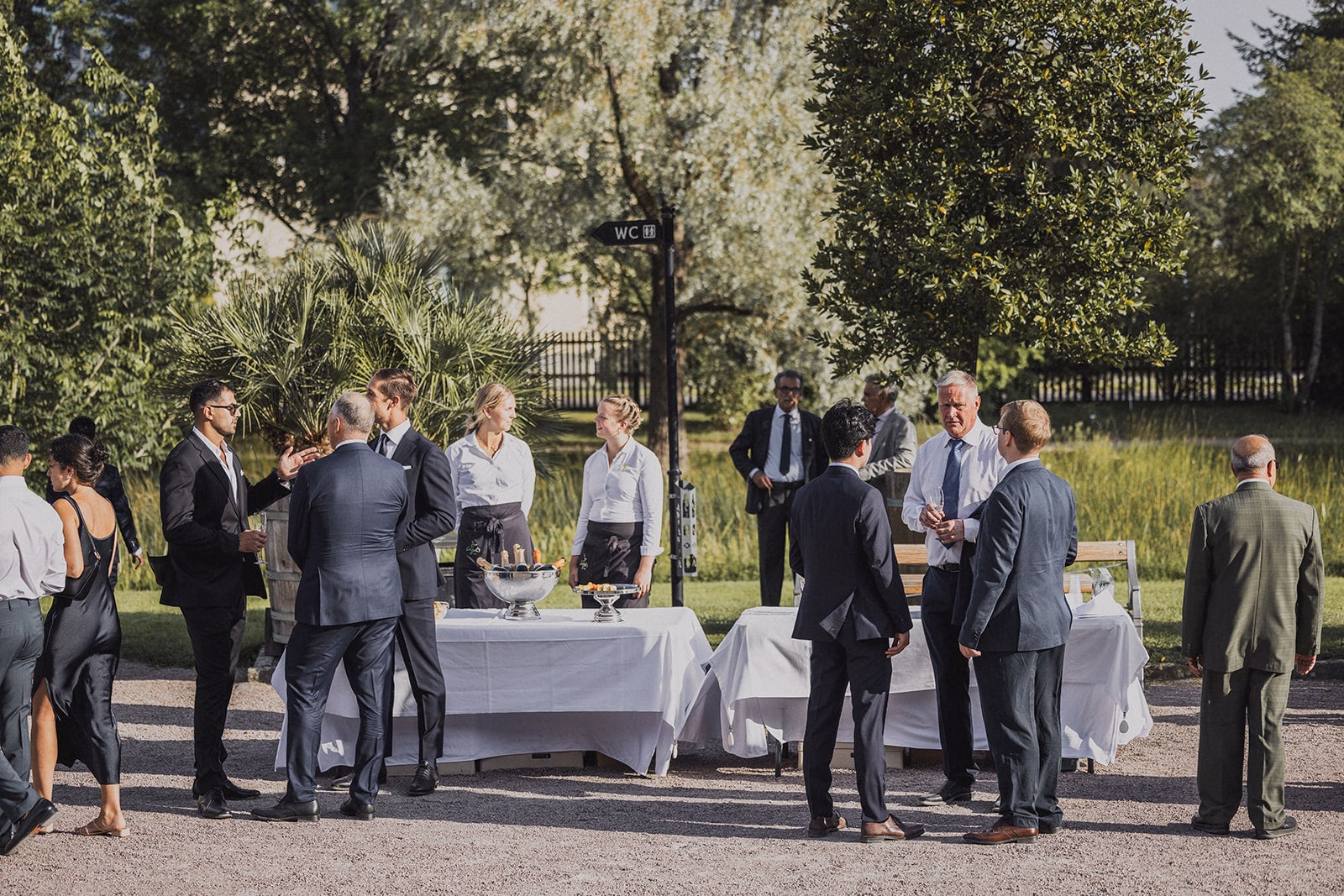 Wedding guests talking together during the outdoor reception.