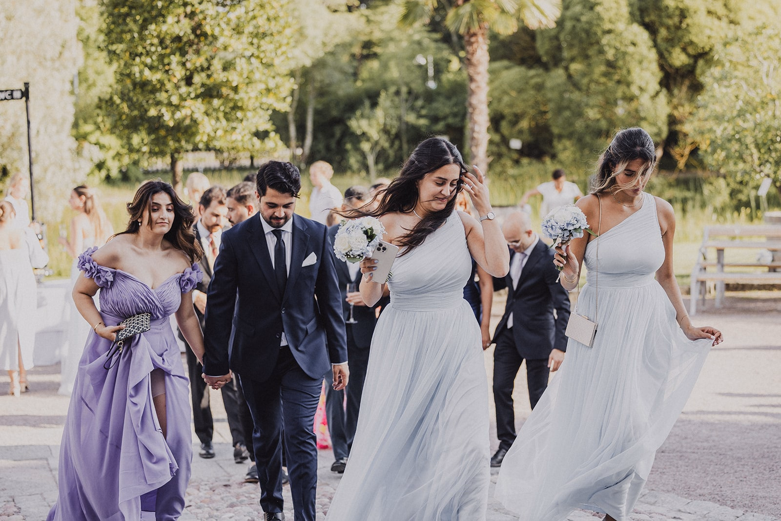 Wedding guests walking together towards the reception.