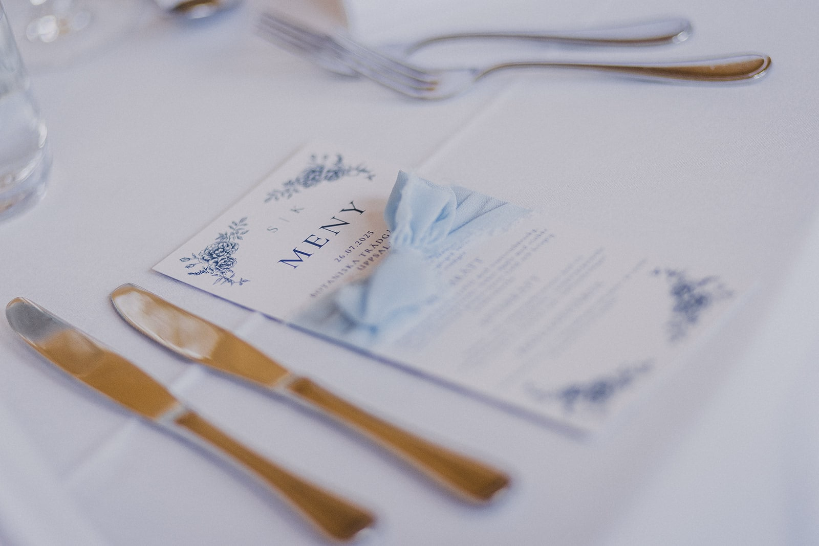 A blue and white place setting prepared for the wedding dinner.