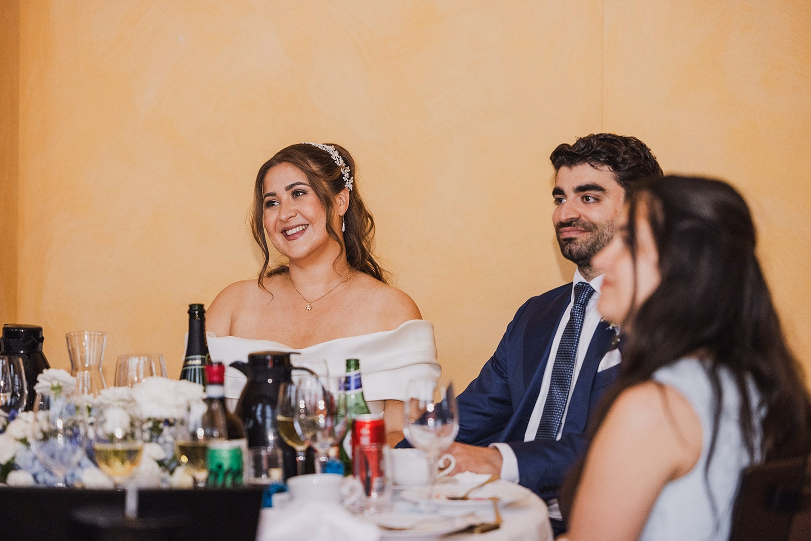 Sara and Kamran listening together during the dinner speeches.