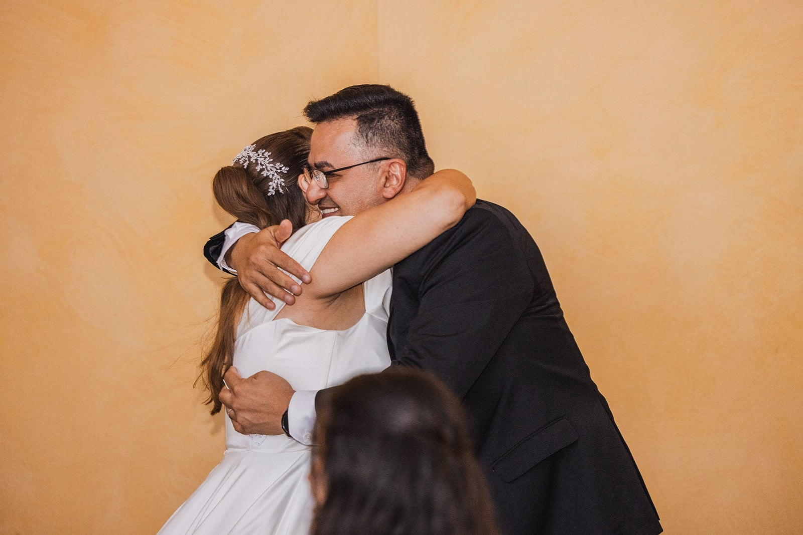 Sara and Kamran embracing during the reception.