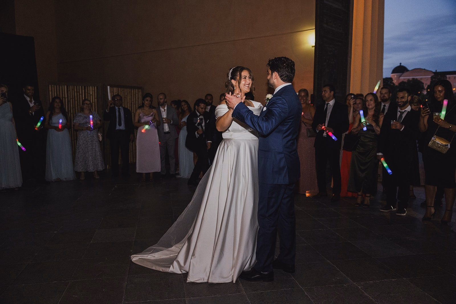 Sara and Kamran beginning their first dance as guests gather around them.