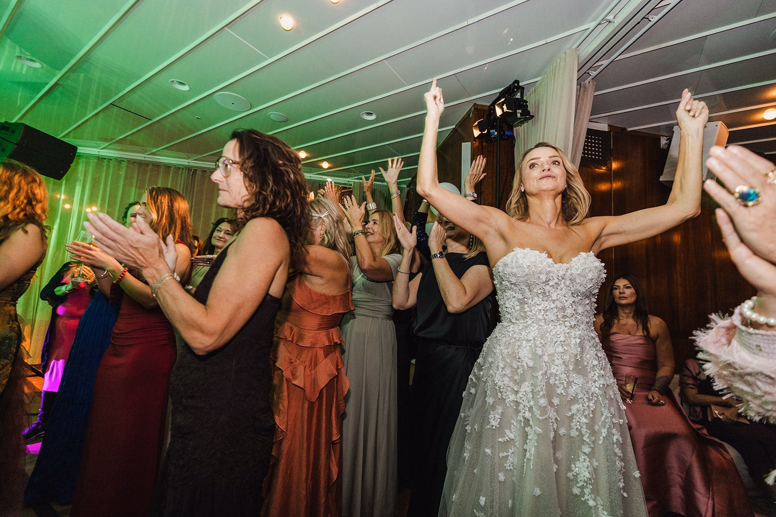 The bride dancing with friends during the evening party.