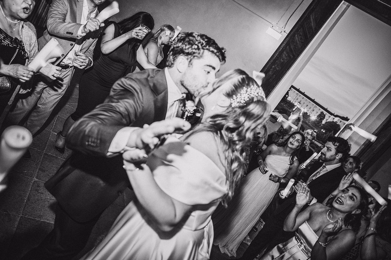 Sara and Kamran kissing in the middle of the wedding party.