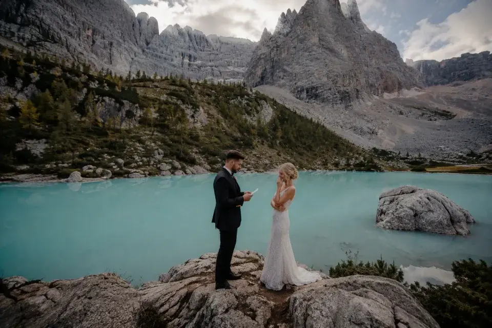 A bride and groom exchanging vows beside Lago di Sorapis near Cortina d'Ampezzo.