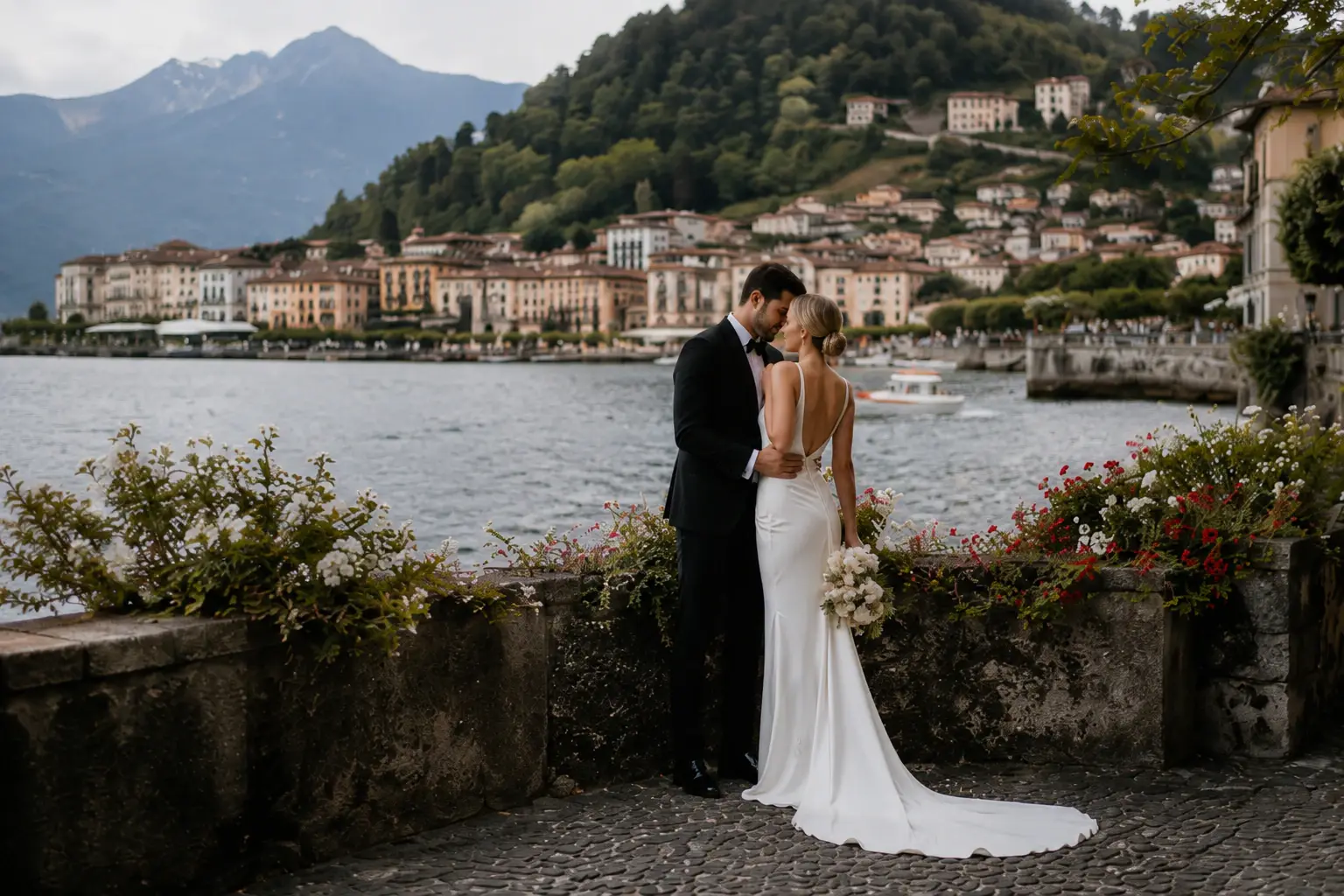 Bride and groom embracing by the waterfront in Bellagio at sunset, romantic Lake Como destination wedding photography in Italy