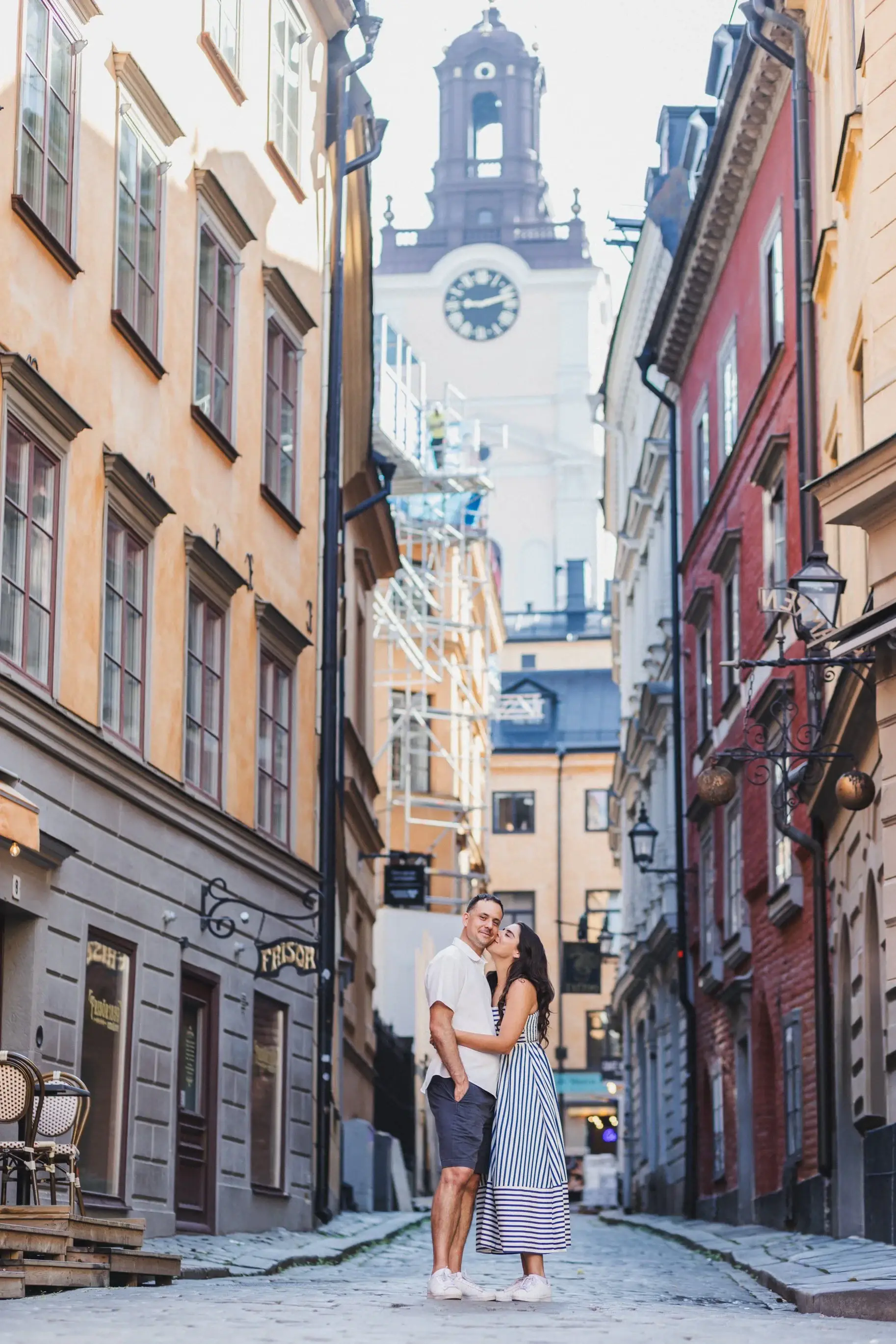 Couple walking through a narrow street in Stockholm.