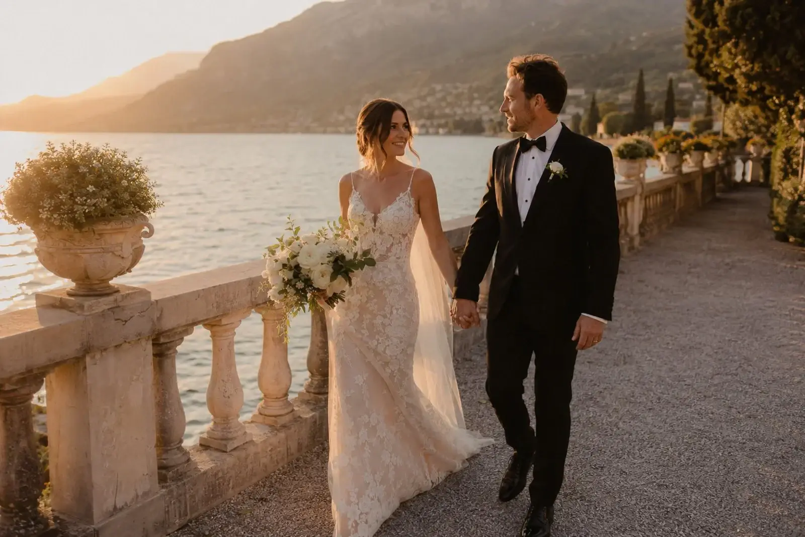 Newlyweds walking along a lakeside terrace at Lake Garda.